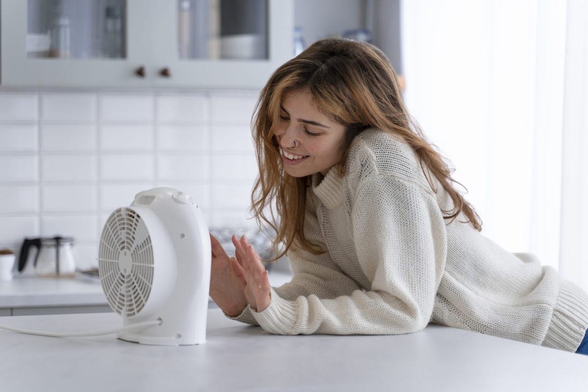 medium-shot-smiley-woman-with-small-heater